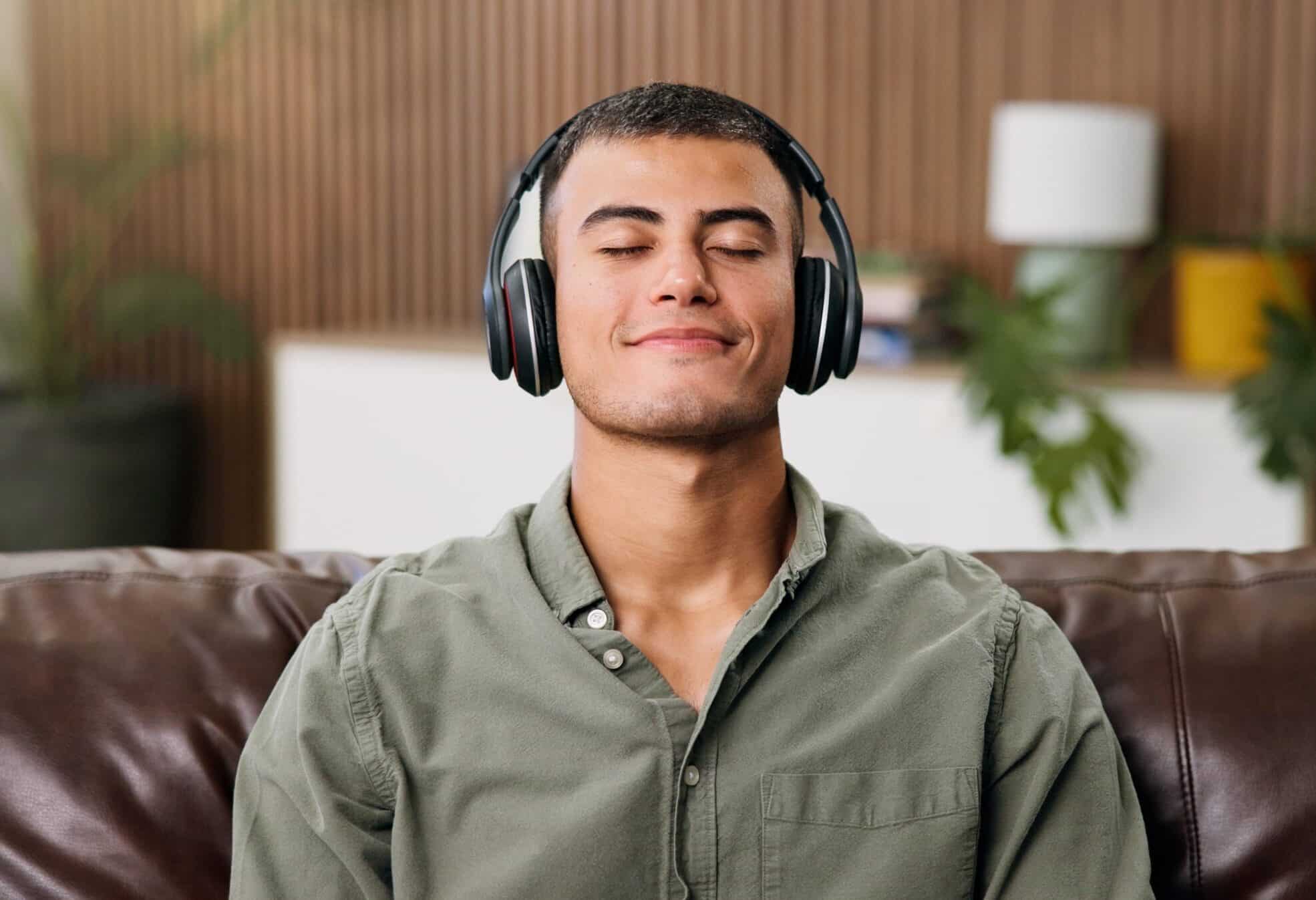 Man,,Headphones,And,Relax,On,Sofa,With,Audio,Streaming,,Chill
